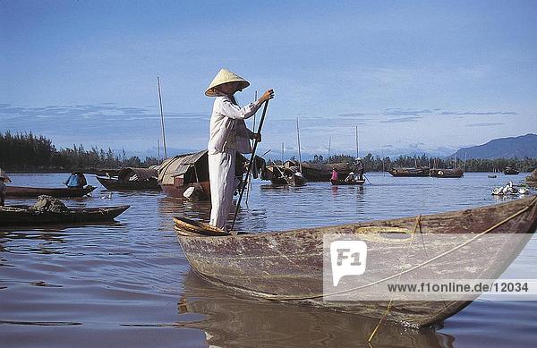 Woman rowing boat in river  Vietnam