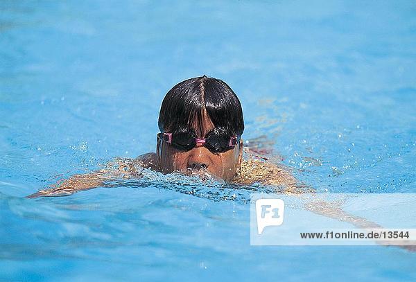 Child swimming in swimming pool