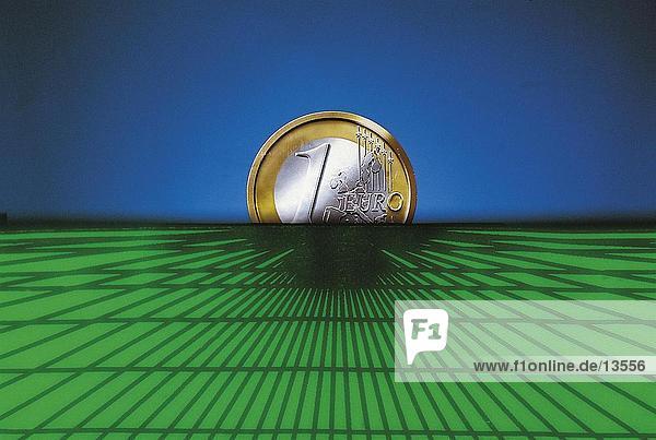 Close-up of euro coin at horizon