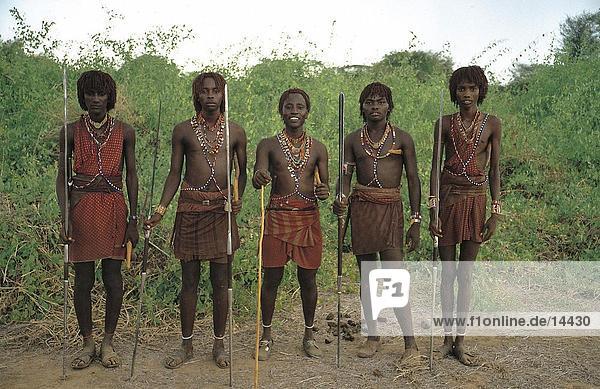 Group of young men holding spears  Kenya