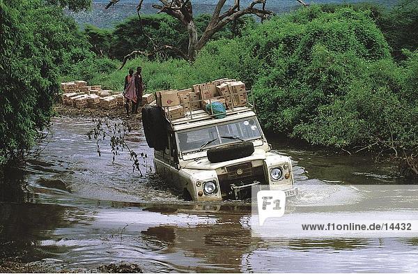 Loaded jeep crossing river  Kenya