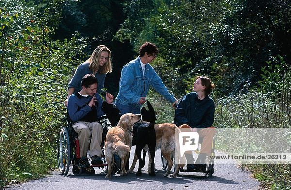 Handicapped people with dogs in park