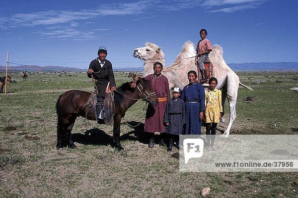 Mongol family with camel and horse  Independent Mongolia
