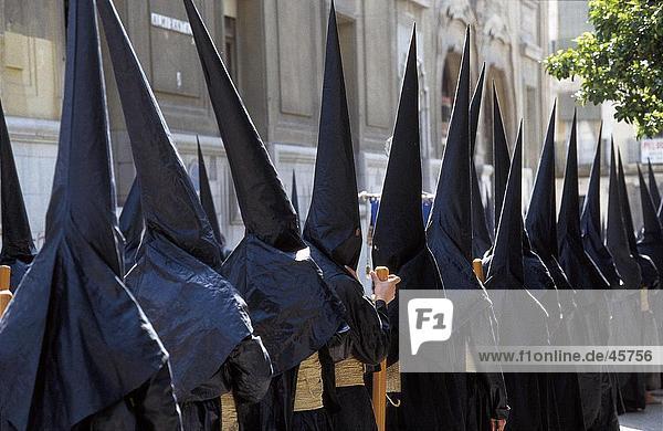 Masked men in holy week procession  Semana Santa  Seville  Andalucia  Spain