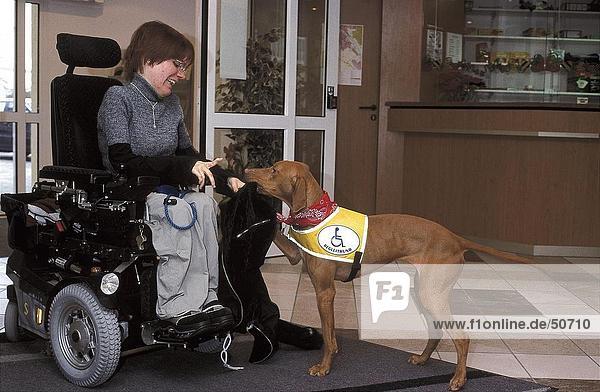 Handicapped woman playing with dog