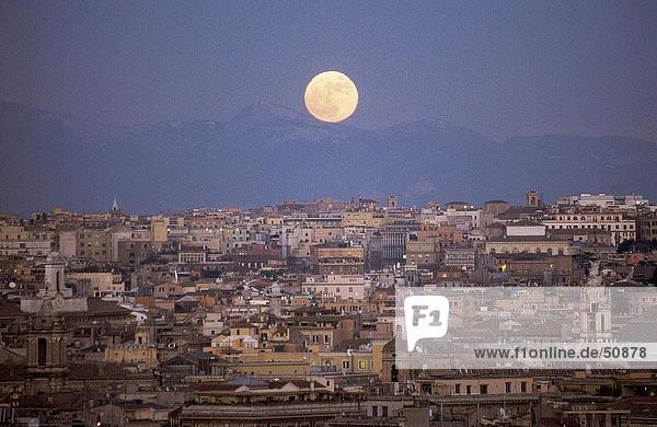Moon over cityscape  Rome  Italy