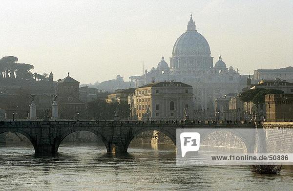 Bridge across river with church in background  Ponte Sant'Angelo  Tiber River  St. Peter's Basilica  Vatican  Rome  Italy