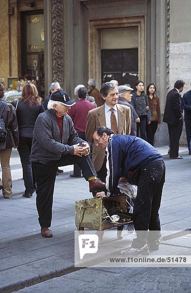 Shoeblack shining customer's shoe in street  Via Toledo  Naples  Italy