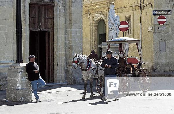 Two coachmen waiting near carriage  Rabat  Malta