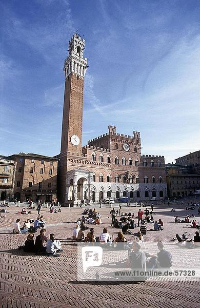 Tourists in front of clock tower  Torre del Mangia  Palazzo Pubblico  Piazza del Campo  Siena  Tuscany  Italy
