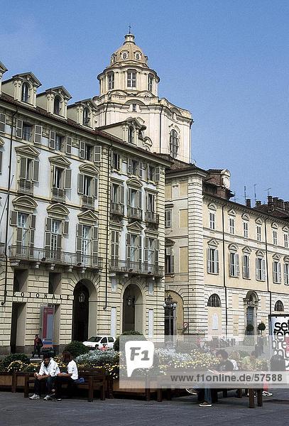 Tourists sitting near palace  Royal Palace Of Turin  Turin  Piedmont  Italy