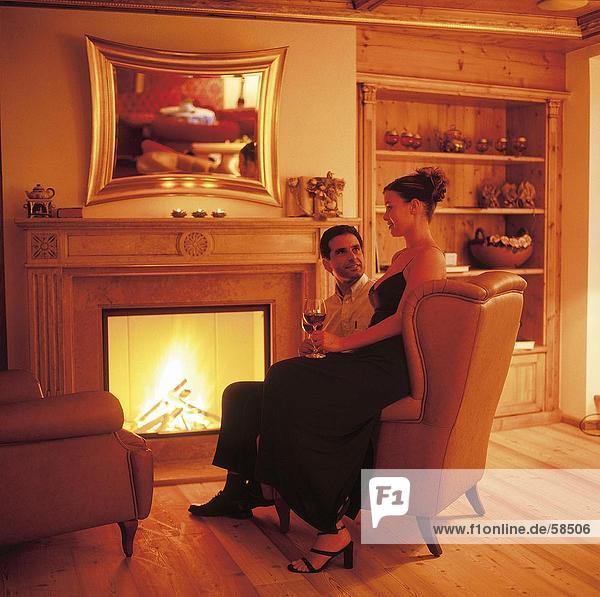 Couple sitting in front of chimney