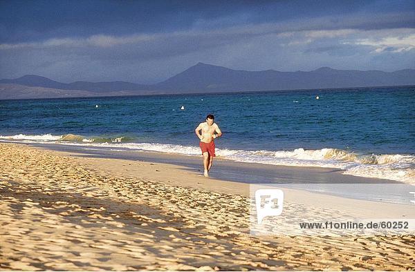 Man running on beach  Fuerteventura  Canary Islands  Spain