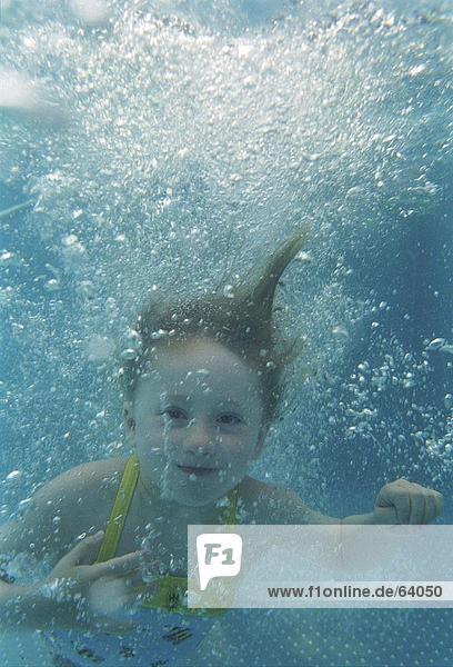 Girl swimming in pool  underwater view