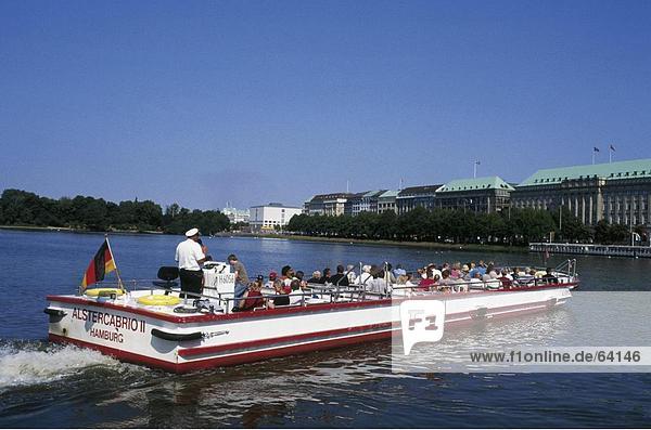 Tourists on tour boat in river  Alster River  Hamburg  Germany
