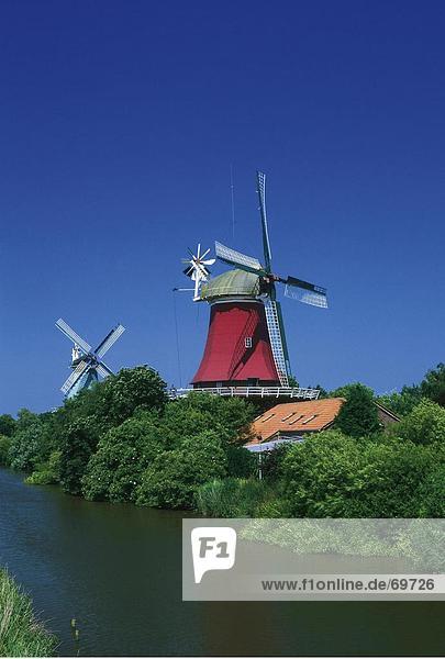 Traditional windmills at waterfront  East Frisia  Greetsiel  Germany