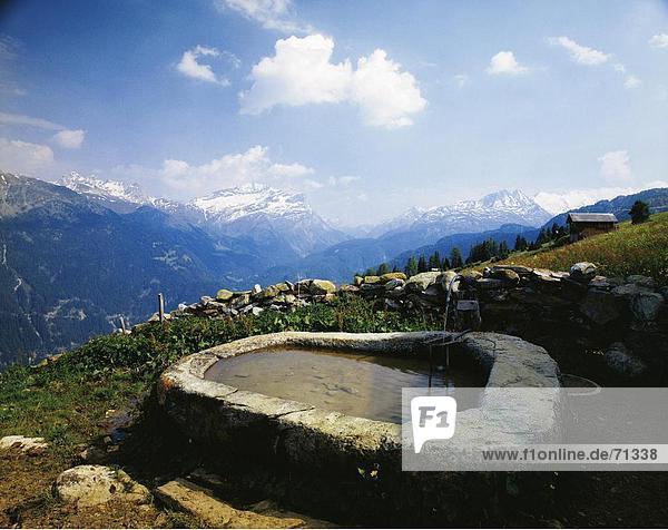 10051971  Alm  Promischus  Bergpanorama  Brunnen  Graubünden  Graubünden  Landschaft  Schnee  Schons  Schweiz  Europa  Stein wal