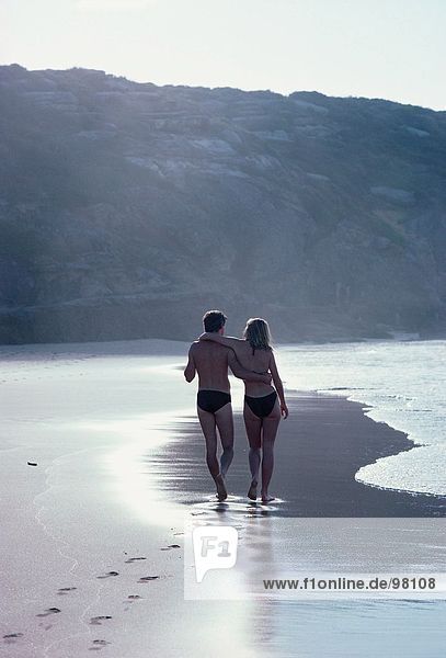 Couple. Beach. Swimwear. Sunrise