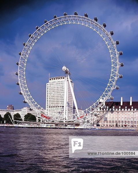 Ferris wheel on riverbank  Thames River  England