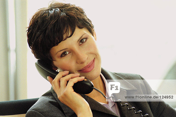 Businesswoman using telephone