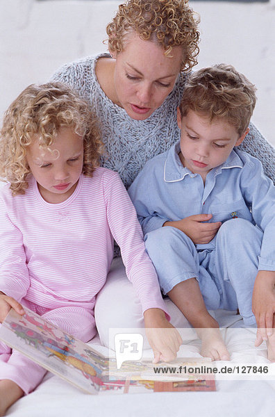 Mother and children reading