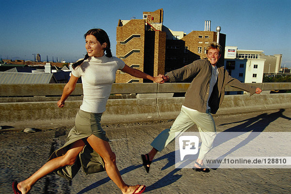 Couple running on roof