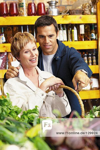 Couple looking at vegetables