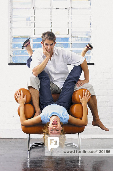Couple playing on an armchair