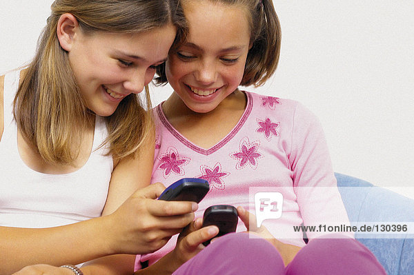 Teenage girls with mobile telephones