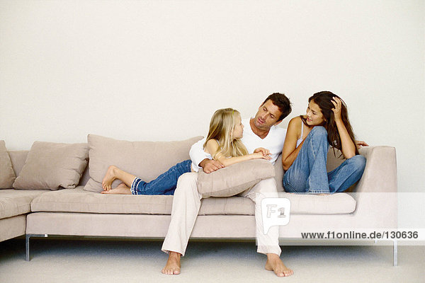 Family sitting on sofa