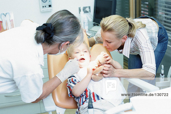 Boy being examined by dentist