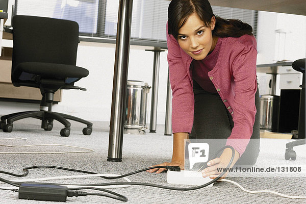 Businesswoman under table in office