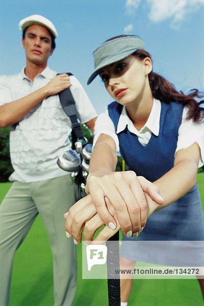 Man and woman playing golf