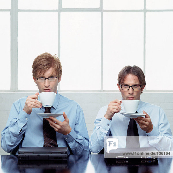 Two businessmen having a coffee break