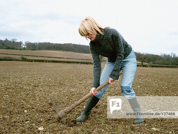 A woman digging the soil