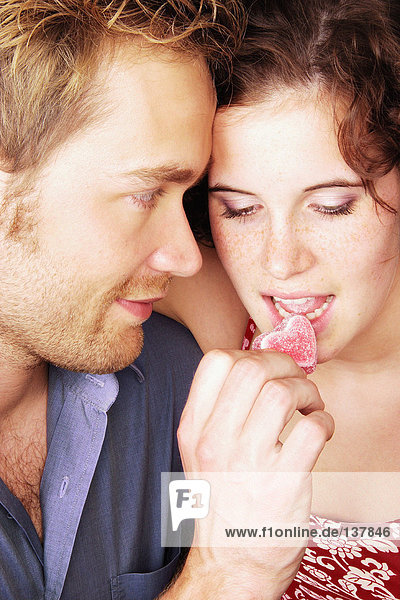 Couple eating heart shaped sweets