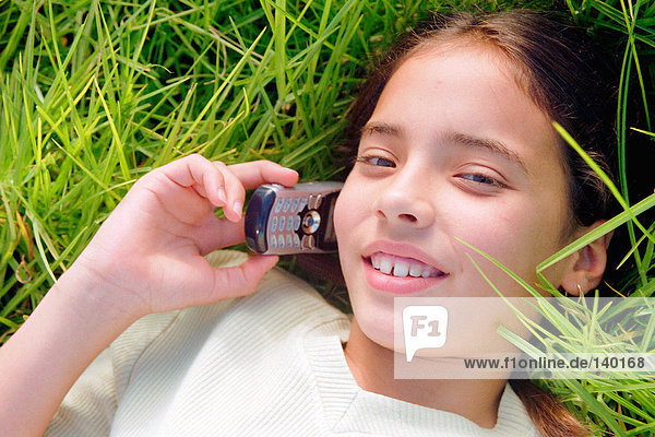 Girl using mobile phone in field