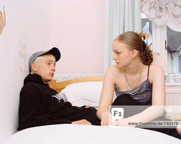 Teenage couple on bed