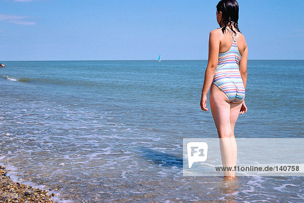 Girl standing in the sea