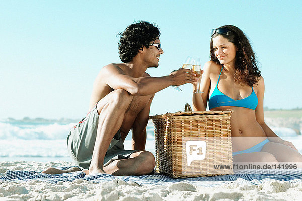 Couple having picnic on beach