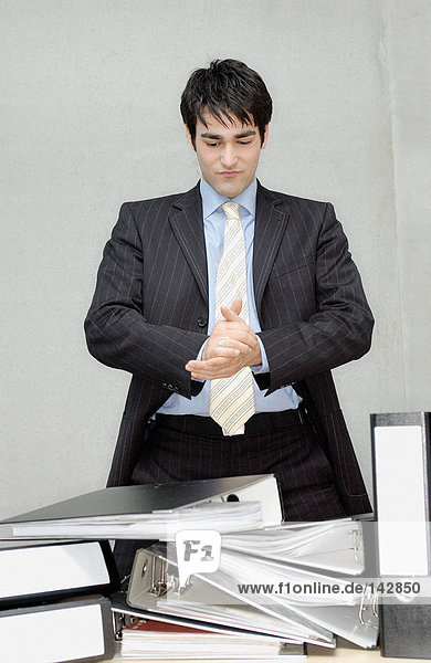 Businessman with hands clasped