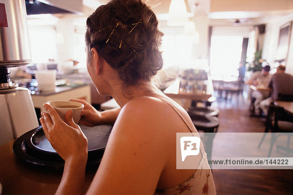 Young woman having coffee