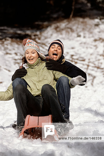 Couple riding a sleigh