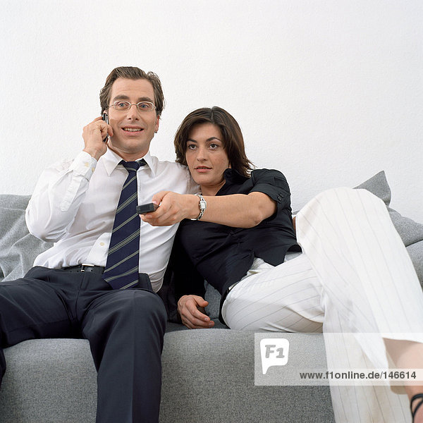 Couple sitting relaxed on sofa