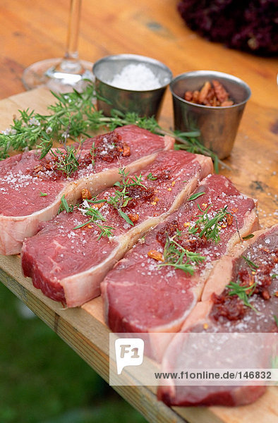 Grilling steaks with herbs