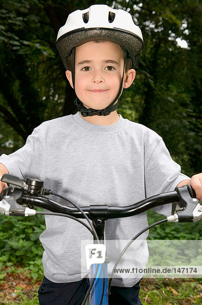 Portrait of a boy learning to ride his bike