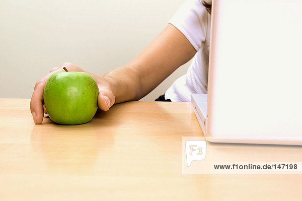 Businesswoman holding an apple
