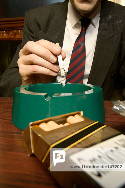 A businessman smoking in a pub