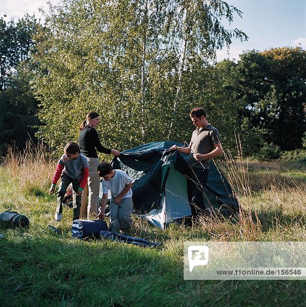 Family erecting a tent