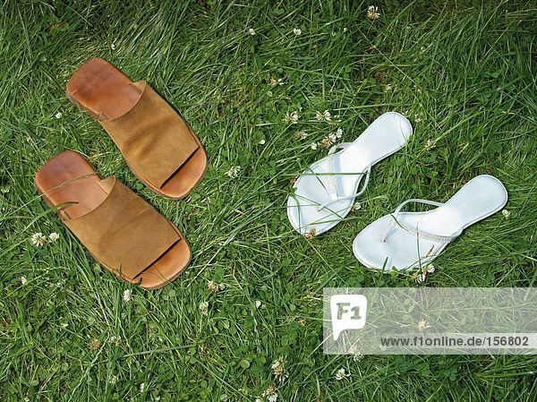 Zwei Paar Sandalen auf dem Rasen